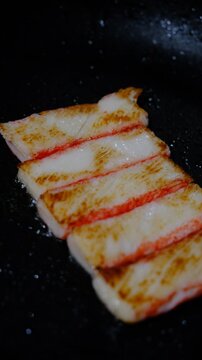 Fish stick. Snow crab immitation, surimi sticks frying. Iron cast pan. Seafood