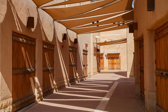 Traditional wooden shop doors and sun shade sails in an alley of Al Dho historical district, Riyadh, Saudi Arabia