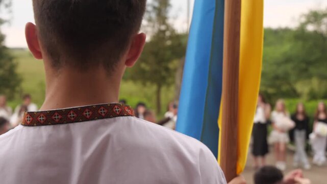 Ukrainian boy standing with the flag of Ukraine