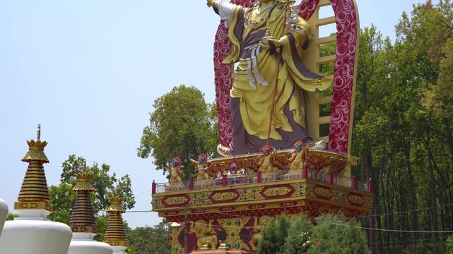 Planning up reveal shot showing the great statue of Guru Padmasmabhava, Guru Dregpa Kundul the tamer showing Rinpoche in wrathful form at Mindrolling Monastery in Dehradun