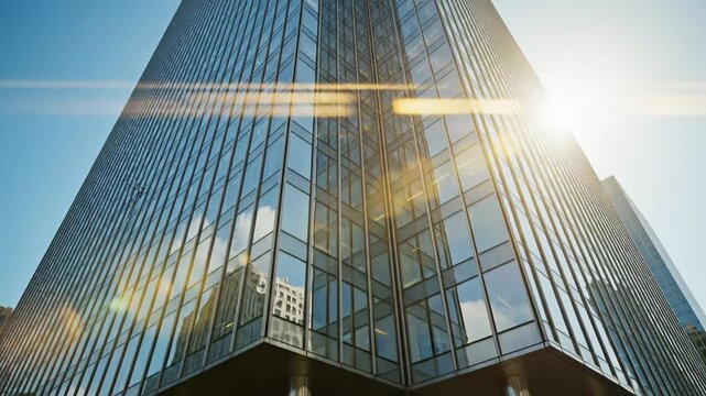 Vibrant green leaves in foreground with modern glass office building exterior