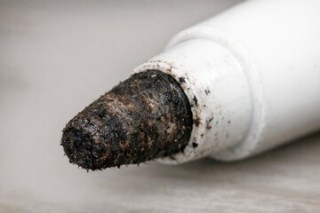 Obraz premium Close-up shot of a white pipe with dirt and debris accumulated on its surface