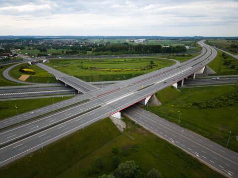 Aerial wide-angle view of a large highway interchange cloverleaf junction. Modern freeway network and transportation infrastructure in Poland.