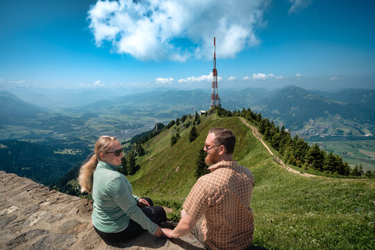 Couple admiring the technology and infrastructure of the telecommunication tower "Sender Gr&uuml;nten" on the &Uuml;belhorn near Sonthofen, ideal for broadcasting technology marketing