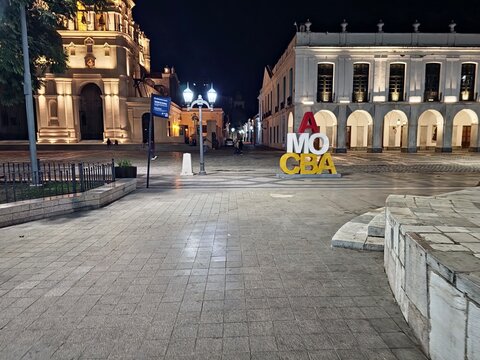 Cordoba, Argentina - April 10, 2026: AMO CBA sign and Cabildo building at night
