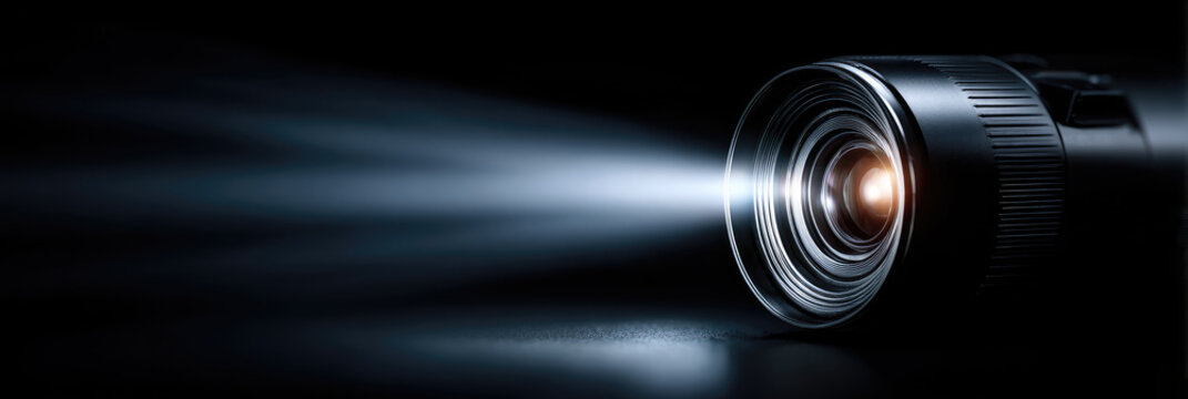 Portable mini projector casting a bright light beam, creating an immersive home cinema experience, illustrating modern entertainment technology and video projection