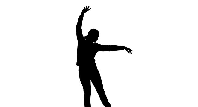 Silhouette of a dancer performing a backbend with arms raised