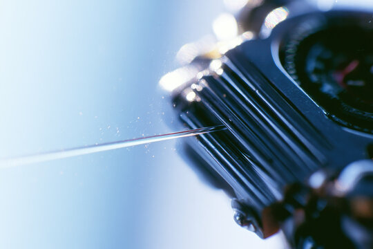 Fiber optic cable splicing macro photography glass fiber metallic groove alignment daylight office window negative space high grain subtle dust sharp focus optic strand core cable connector metal