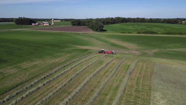 farm tractor pulling a round baler-wrapper combination machine from above