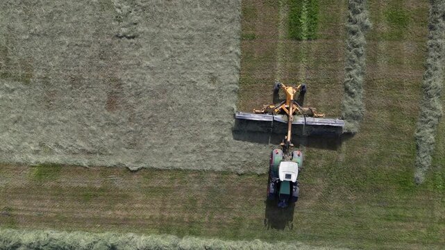 Farm tractor pulling a hay merger from above