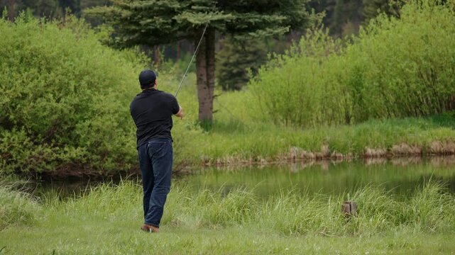 Man Casting Fishing Rod into Pond