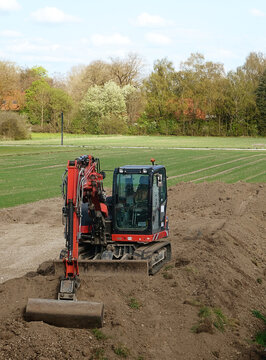 excavator at work in the construction site digging and moving earth