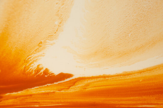 Sunset in warm colors over ocean waves with clouds in the sky during evening hours
