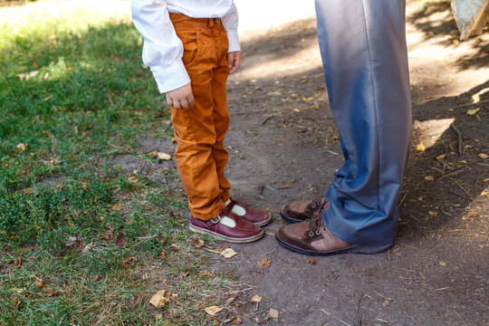 Father and son footwear comparison with retro and modern styles outdoors