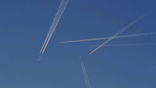 A composite of several jet aircraft crossing paths in a crowded sky