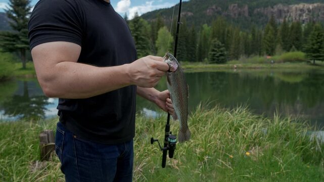 Man Holding Rainbow Trout Caught While Fishing in Colorado
