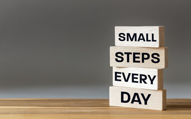 Obraz premium Small steps every day. Motivational slogan. Working on oneself. Conceptual words, Business symbol. Achieving goals. Project for a lifetime