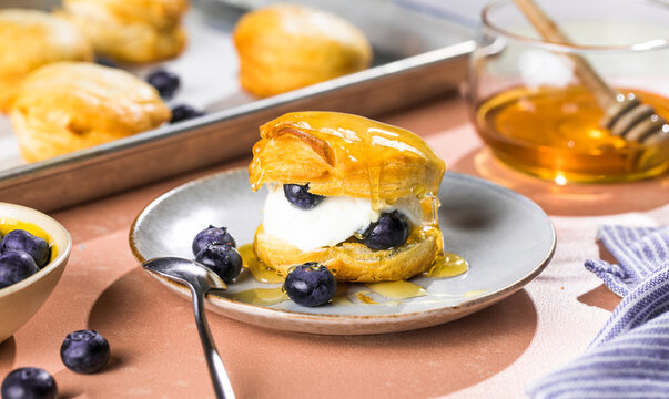 Scone Filled with Blueberry  and Clotted Cream on a plate