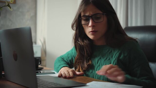 Video of a frustrated young businesswoman analyzing declining profit charts and financial losses. Business crisis, bankruptcy risk and economic downturn concept.
