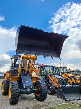Voronezh, Russia - April 1, 2026.Heavy duty Chinese wheel loader and backhoe excavators displayed in Russian dealership lot promoting construction equipment renewal