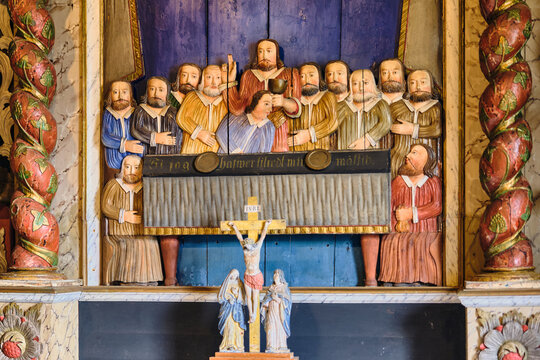 Lund, Sweden - 02 August 2025: View of a historic wooden relief depicting the Last Supper with Jesus and the apostles, located inside a traditional building at the Kulturen open air museum.