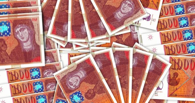 North Macedonia denars money banknotes in a cash fan mosaic pattern loop. 1000 MKD notes. Abstract concept of bank, finance, economy seamless and looped design background.