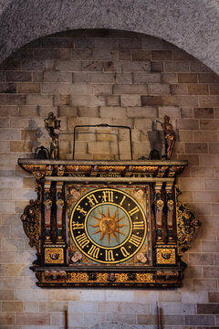 Lund, Sweden - 02 August 2025: View of the ornate astronomical clock Horologium Mirabile Lundense with its sun face and intricate carvings mounted on a stone wall inside the Lund Cathedral.