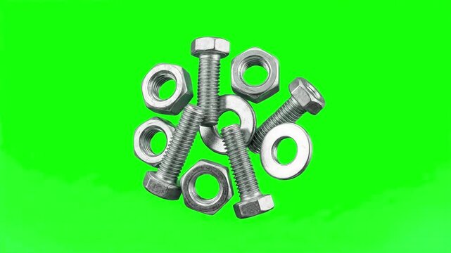 A pile of metallic iron bolts, hex nuts, and flat washers rotates and settles against a solid chroma key green background. Ideal for industrial hardware advertisements, construction explainers, and en