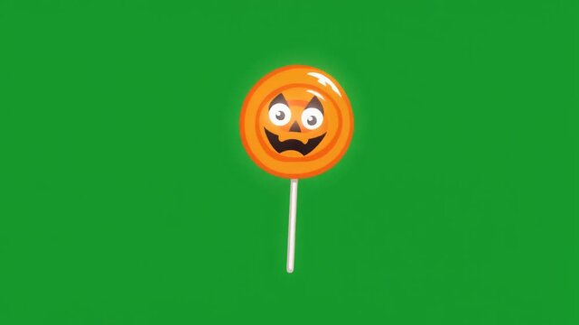 A cute orange pumpkin lollipop isolated on green screen chroma key background.