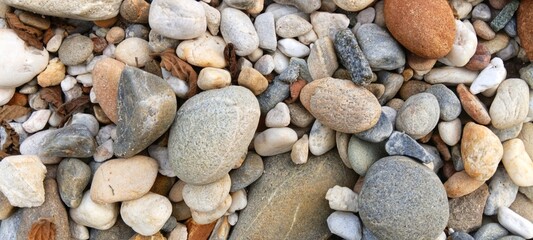 A circular spiral pattern meticulously formed by smooth river stones, representing infinity and...