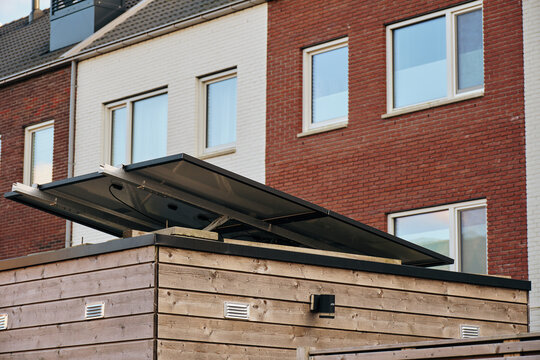 Assen, Netherlands - 01 March 2025: View of the New Residency development at the former Veemarkt with solar panels and heat pump units on a wooden roof against modern brick houses.