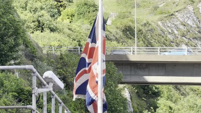 Union Jack waving against bridge 4K