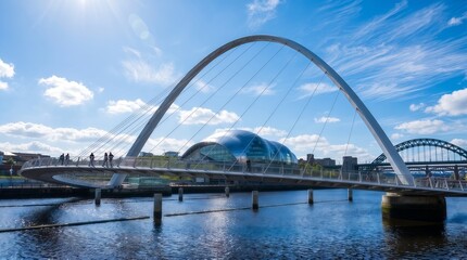 Fototapeta premium Modern white arch bridge spanning calm river with distant mountains under blue sky