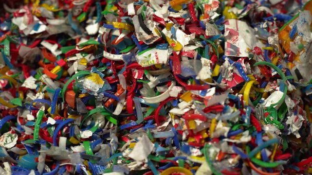 View of shredded colorful plastic waste fragments piled together for recycling in Bogura, Rajshahi Division, Bangladesh.