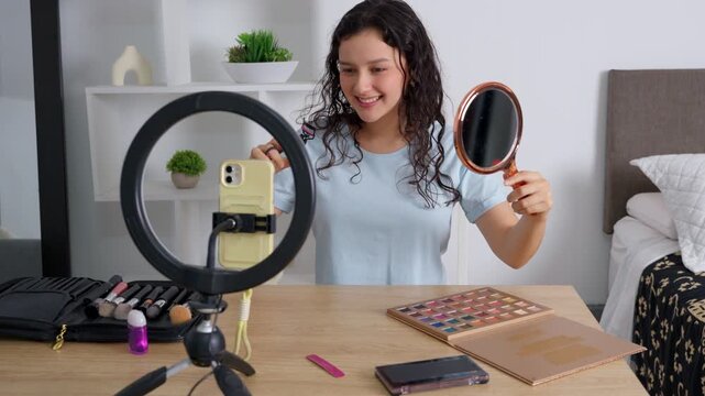 Young female influencer vlogging a makeup tutorial