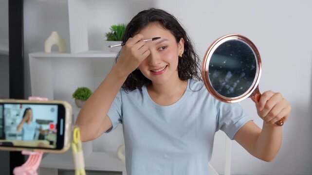 Young beauty blogger influencer streaming live makeup tutorial