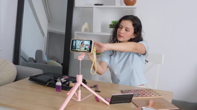 Influencer live streaming a makeup tutorial with a smartphone