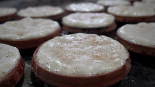 View of traditional Mishti Doi yogurt with a creamy bubbly texture served in terracotta clay pots in Bogura, Rajshahi Division, Bangladesh.