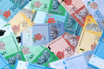 Malaysian ringgit money bills in pile on table. Malaysia MYR currency cash close up © Viktor