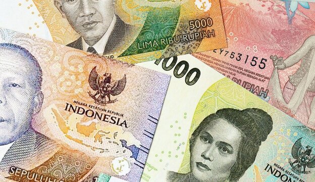 Indonesian rupiah money bills in pile on table. Indonesia IDR currency cash close up