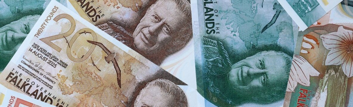 Falkland Islands pound money bills in pile on table. Falkland Islands FKP currency cash