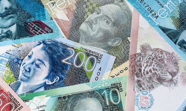 Peruvian sol money bills in pile on table. Peru PEN currency cash close up