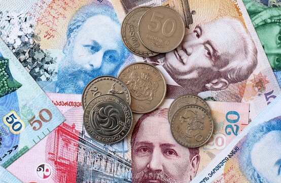 Georgian lari money banknotes and coins on table. Georgia cash bills of GEL currency
