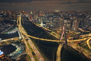 Aerial night view of Octávio Frias de Oliveira Bridge, the cable-stayed bridge over Marginal Pinheiros in São Paulo, with vehicle traffic - São Paulo, Brazil © Tales