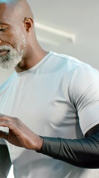 Vertical video: Responding to unseen prompt man gesturing and focusing in studio with black sleeves