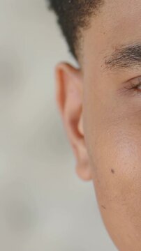 Vertical video: Opening right face on set, eyelid lifting and cheek lifting forming smile with mole