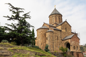Fototapeta premium Western Asia, South Caucasus, Republic of Georgia, Tbilisi. The Metekhi Virgin Mary Assumption Church.