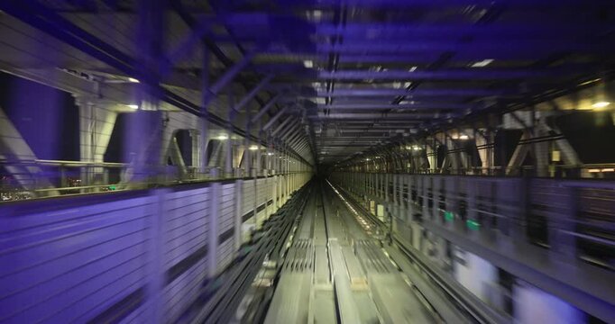 Train goes through city at night,  concept of speed, time lapse