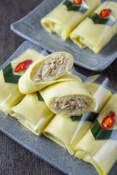 Traditional Javanese semar mendem, savory chicken stuffed sticky rice wrapped in thin egg omelet, Authentic Indonesian snack