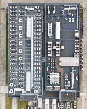 Aerial view of the industrial rooftop of the T-Mobile Datacenter with HVAC cooling units and ventilation systems in Warsaw, Mazowieckie, Poland.